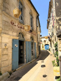 Street in Vallabrègues with hanging wicker baskets outside the former 19th-century Grand Café, now home to the Basketry Museum.