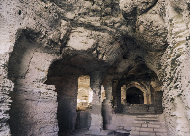 Saint-Roman Abbey – Interior Architecture Interior of Saint-Roman Abbey showing rock-cut spaces, arches and openings leading to other parts of the monument.